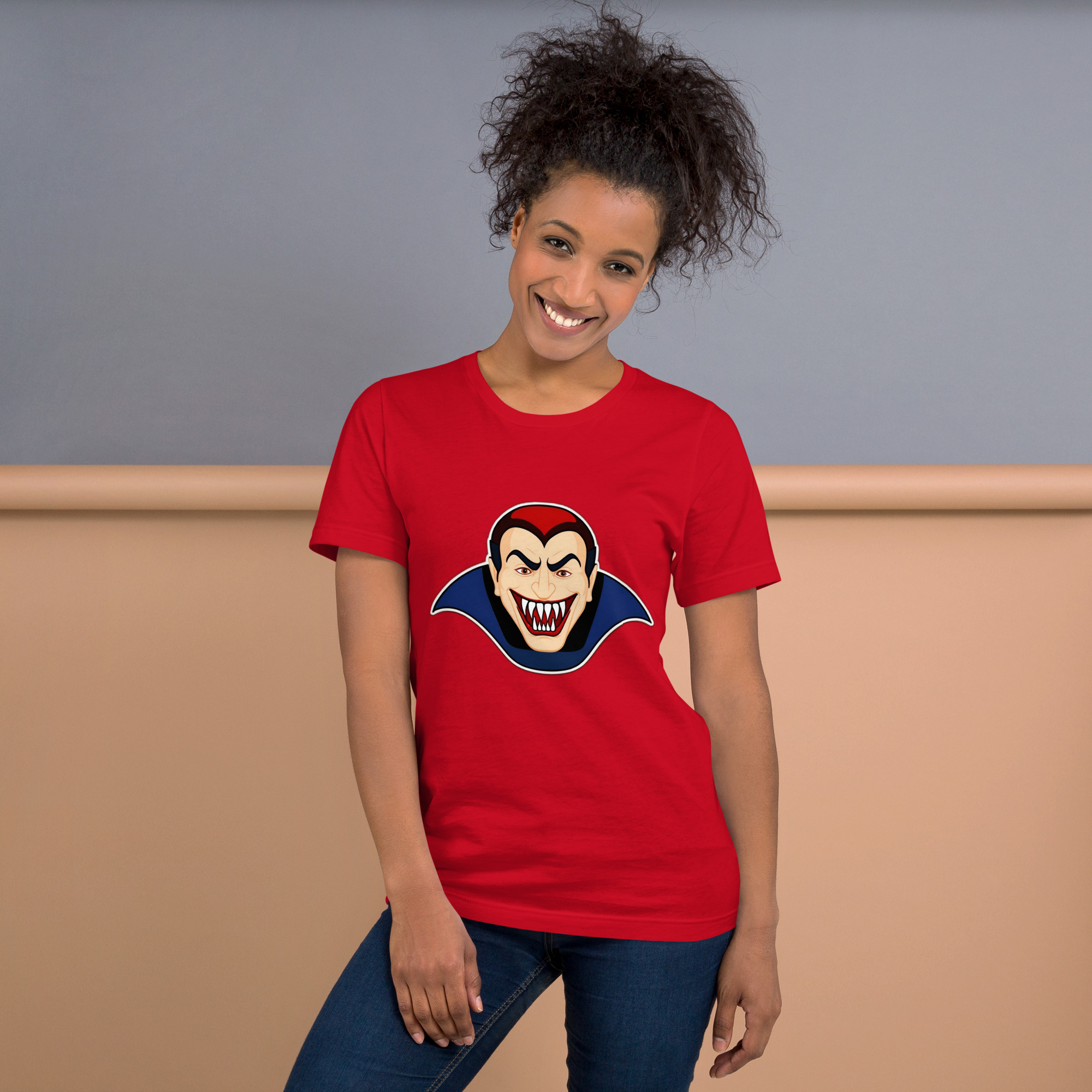 Woman wearing red vampire t-shirt, smiling indoors.