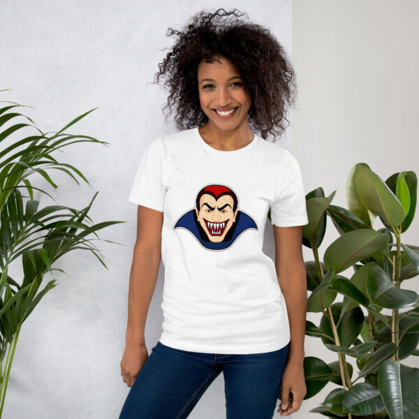 Woman wearing vampire-themed T-shirt smiles near plants.