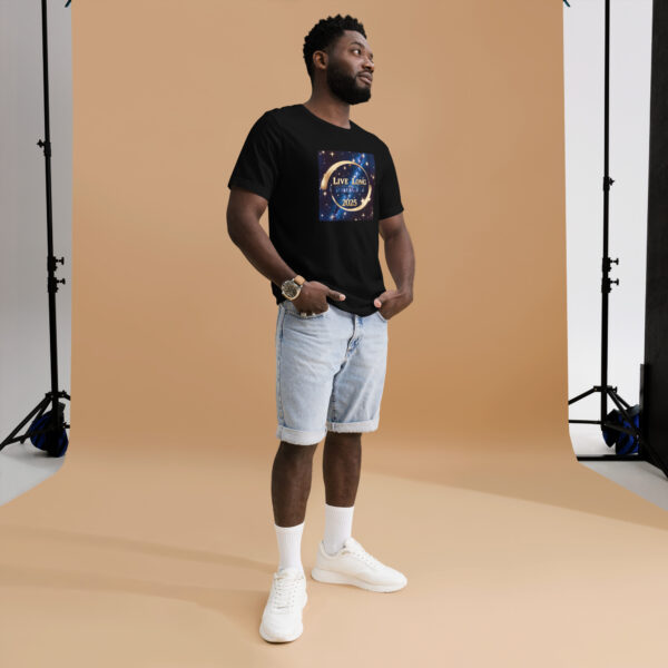 Man wearing black T-shirt and denim shorts in studio.