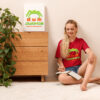 Woman in red t-shirt taking notes by plant